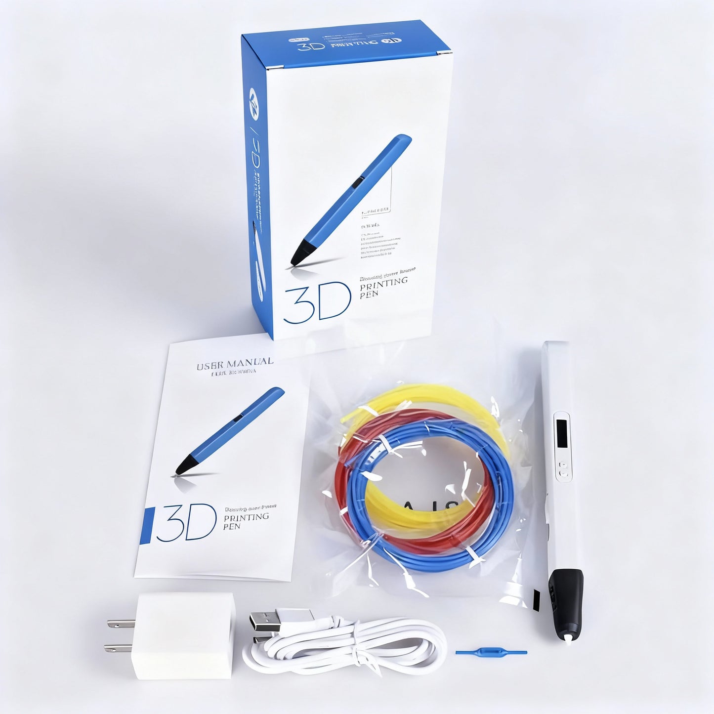 Stylo 3D Pro Lite - contenu du coffret avec stylo blanc, manuel, adaptateur USB, câble et 3 filaments PLA (bleu, rouge, jaune).